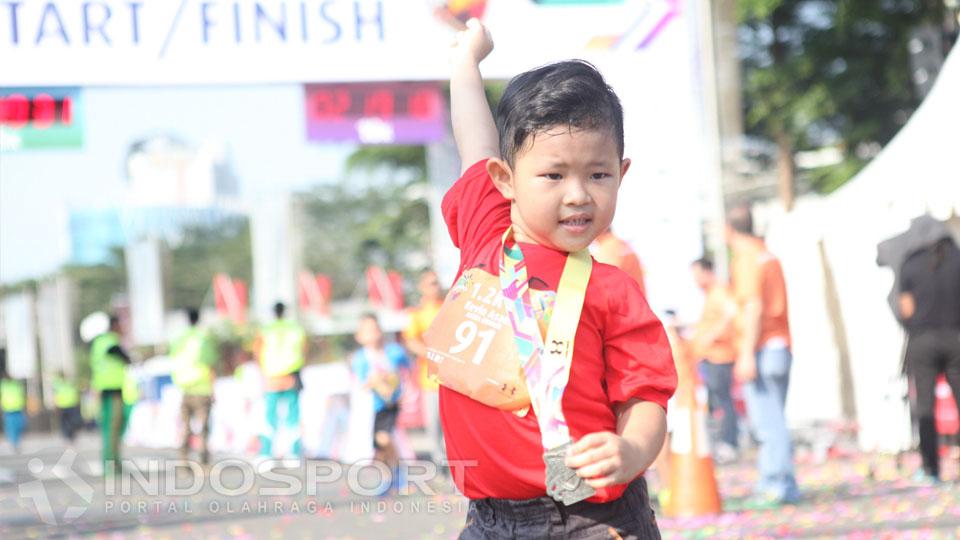 Seorang anak tengah bergembira mengikuti acara Serpong Green Warrior Run 2016.